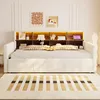 A white daybed with integrated storage and LED lighting, shown in a bedroom setting with decorative items and a rug. Voir les images du produit