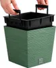 Hands holding the inner basket of a green planter. Produktbild-Vorschau
