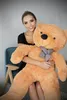 A woman is sitting on a chair and hugging a large teddy bear. Podgląd zdjęcia produktu