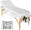 A white massage table with wooden legs and a carrying case. Náhled obrázku produktu
