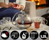A person is enjoying tea in a cozy setting with a teapot and cups on a table. Produktbild-Vorschau