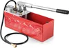 A red manual hydraulic pressure testing pump with a silver lever and black handle, connected to a black hose with a brass fitting. The pump has instructional diagrams printed on its side. Produktbild-Vorschau
