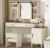 A vanity table with a mirror, stool, and cabinet in a room with white shiplap walls. Produktbild-Vorschau