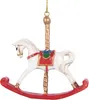 A white rocking horse Christmas ornament with a red base and gold pole. Náhled obrázku produktu