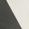 A close-up view of a textured surface divided diagonally into black and white sections. Produktbild-Vorschau