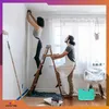 A couple painting a room, with a toolbox in the foreground. Produktbild-Vorschau