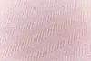 A close-up shot of a textured fabric with a herringbone pattern. Produktbild-Vorschau