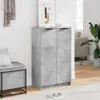 A shoe cabinet with two doors in a concrete gray finish is shown in a room setting, next to a bench and a plant. Náhľad obrázku produktu