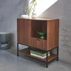 A wooden sideboard with black metal legs, set against a grey concrete wall. Anteprima dell’immagine prodotto