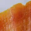 A close-up view of a textured orange surface, possibly fabric or a food item. Produktbild-Vorschau