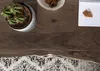 A top-down view of a wooden table with a potted cactus, a bowl of cookies, and a notebook with crackers. Produktbild-Vorschau