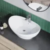 A bathroom sink with a faucet on a countertop, with green tile backsplash and a mirror in the background. Produktbild-Vorschau