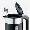 Close-up of the top part of a black electric kettle, with the lid open and a filter detached. Produktbild-Vorschau
