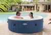 A couple relaxing in an inflatable hot tub next to a swimming pool. Produktbild-Vorschau