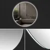 A round illuminated mirror reflects a modern bathroom with a shower. Produktbild-Vorschau