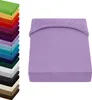 A stack of folded fitted sheets in various colors is shown on the left, and a single purple fitted sheet is displayed on the right. Produktbild-Vorschau
