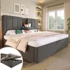 A bedroom scene featuring a bed with a headboard, bedside tables, and a window in the background. Produktbild-Vorschau
