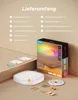 A flat lay of a ceiling light and its accessories, with the product box in the background. Produktbild-Vorschau