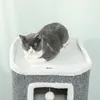 A gray and white cat is sleeping on top of a cat tree. Produktbild-Vorschau