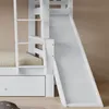 A close-up view of a white bunk bed with a slide and ladder. Anteprima dell’immagine prodotto