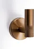 A close-up shot of a single bronze-colored bathroom hook mounted on a white wall. Anteprima dell’immagine prodotto