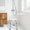 A bathroom scene with a shower stool, vanity, and shower. Produktbild-Vorschau