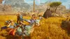 Two people riding on large, bird-like creatures through a dry, grassy landscape with mountains in the background. Anteprima dell’immagine prodotto