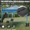 A blue and white striped gazebo is set up in a grassy outdoor area with rain falling. Produktbild-Vorschau