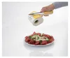 A hand holding a cheese grater over a plate of food. Produktbild-Vorschau