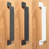 Three door handles in different colors mounted on a wooden surface. Produktbild-Vorschau