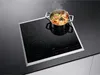 A cooking pot with food is placed on a black glass ceramic hob. Náhled obrázku produktu