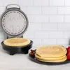 A Batman-themed waffle maker with waffles on a plate. Produktbild-Vorschau