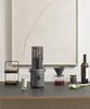 A juicer and coffee making setup on a counter with a painting in the background. Produktbild-Vorschau