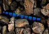 Close-up of lava rocks with blue flames visible between them. Náhled obrázku produktu
