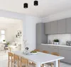 A modern kitchen and dining area with a view into a living room. Voir les images du produit