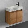 A modern bathroom vanity with a white sink and a wooden cabinet against a concrete wall. Produktbild-Vorschau