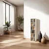 A bright, modern living room with a tall, narrow CD/DVD shelf unit. Voir les images du produit