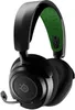 A studio shot of a pair of black gaming headphones with a green accent on the headband. Produktbild-Vorschau