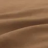 A close-up, textured view of brown fabric, showing folds and curves. Produktbild-Vorschau