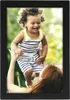 A mother is lifting her happy child in the air outdoors. Produktbild-Vorschau