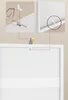 Diagrams showing how to attach a safety bracket to a wall and a product. Produktbild-Vorschau