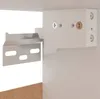 A close-up view of a cabinet mounting bracket attached to a white cabinet. Voir les images du produit