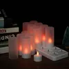 A set of rechargeable LED tea lights with frosted cups and a charging base, displayed on a wooden surface with books in the background. Náhled obrázku produktu