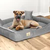 A dog is lying on a gray dog bed. Náhled obrázku produktu
