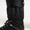 Close-up of the bottom of black pants tucked into a black boot. Produktbild-Vorschau