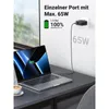 A laptop is charging from a wall charger plugged into an outlet. The charger is shown with a graphic indicating its charging speed and capacity. Produktbild-Vorschau