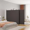 A bedroom scene with a bed, nightstand, and a room divider. Anteprima dell’immagine prodotto
