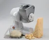 A white and silver electric cheese grater with a block of cheese, grated cheese in a container, and cubed cheese. Podgląd zdjęcia produktu