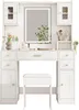A white vanity table with a lighted mirror and a white stool, set against a white background. Produktbild-Vorschau