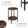 A close-up of a round, two-tiered side table with a wood-grain top and black metal legs, set against a white background. Text overlays describe the product's design and construction. Náhled obrázku produktu